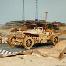 Side view of the Robotime Grand Prix Car on a road in an atmospheric setting