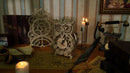 The Robotime Owl Clock and Pendulum Clock in a dark room with lit candles and vintage deco